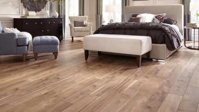 warm wood look laminate flooring in a modern bedroom